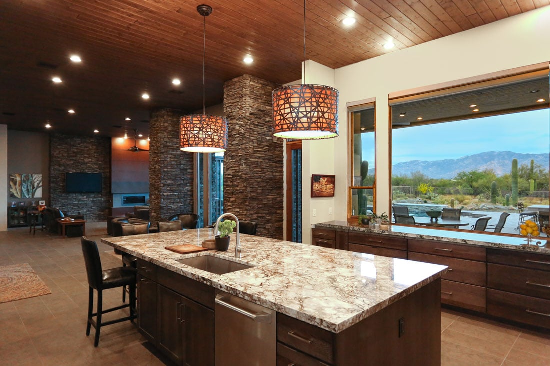 Granite slab island bar and buffet under tongue and groove ceilings with stone