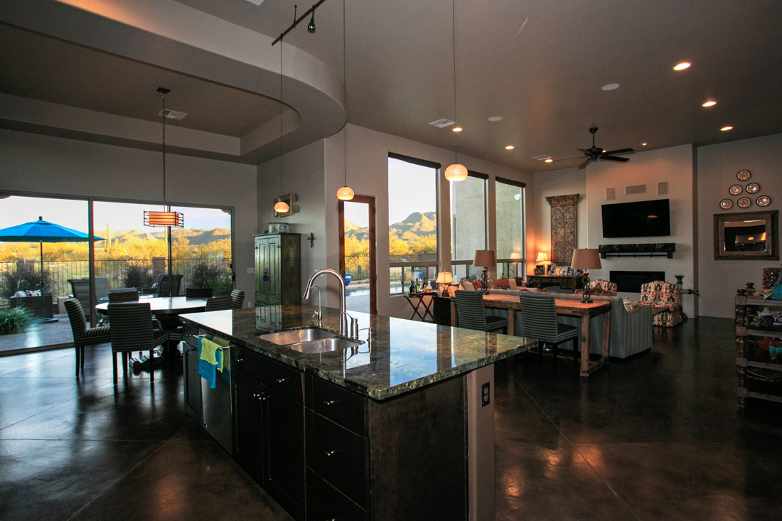 Great Room with open kitchen oversize windows and concrete overlay floors