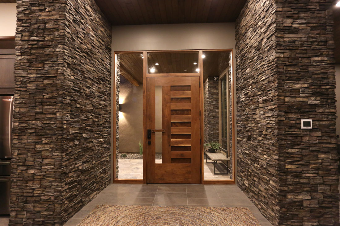Impressive stone entry with handmade custom door